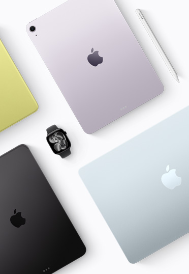 Een bovenaanzicht van verschillende gekleurde Mac- en iPad-devices, met een zwarte Apple Watch in het midden.
